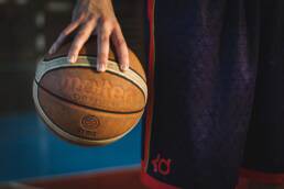 Smarter basketball bets image of a man holding an old basketball