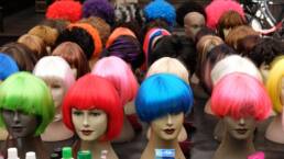 Wacky sports dress-up image of mannequin heads with wigs on