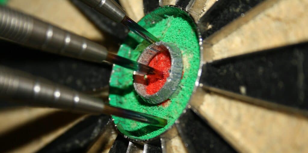 Some darts in a dartboard.